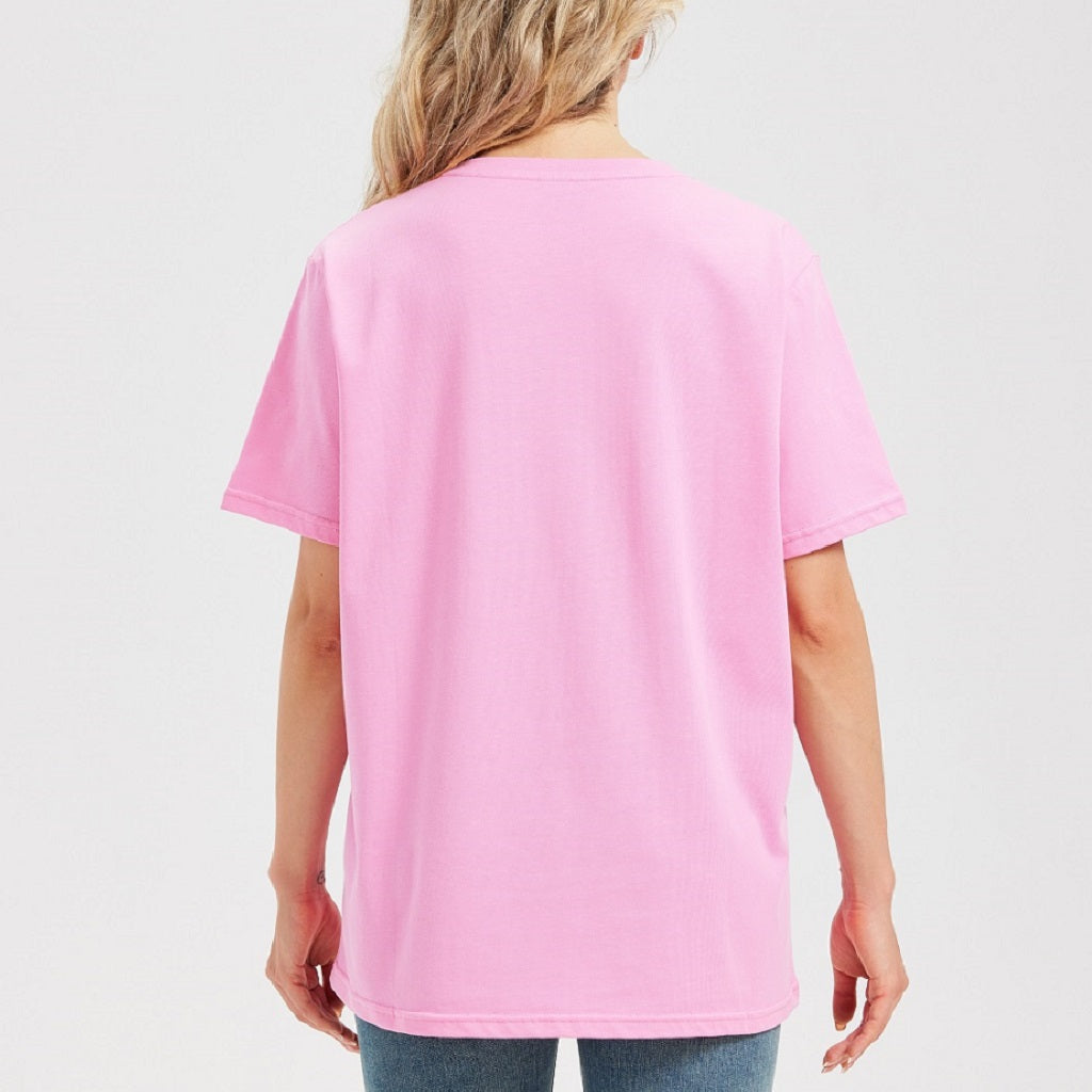 Woman wearing a pink t-shirt and blue jeans on a white background