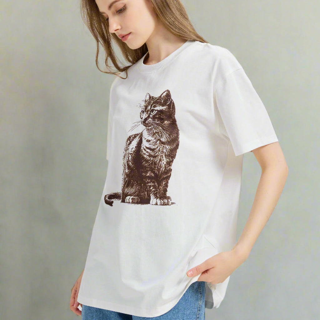 Woman wearing a white t-shirt with a cat graphic