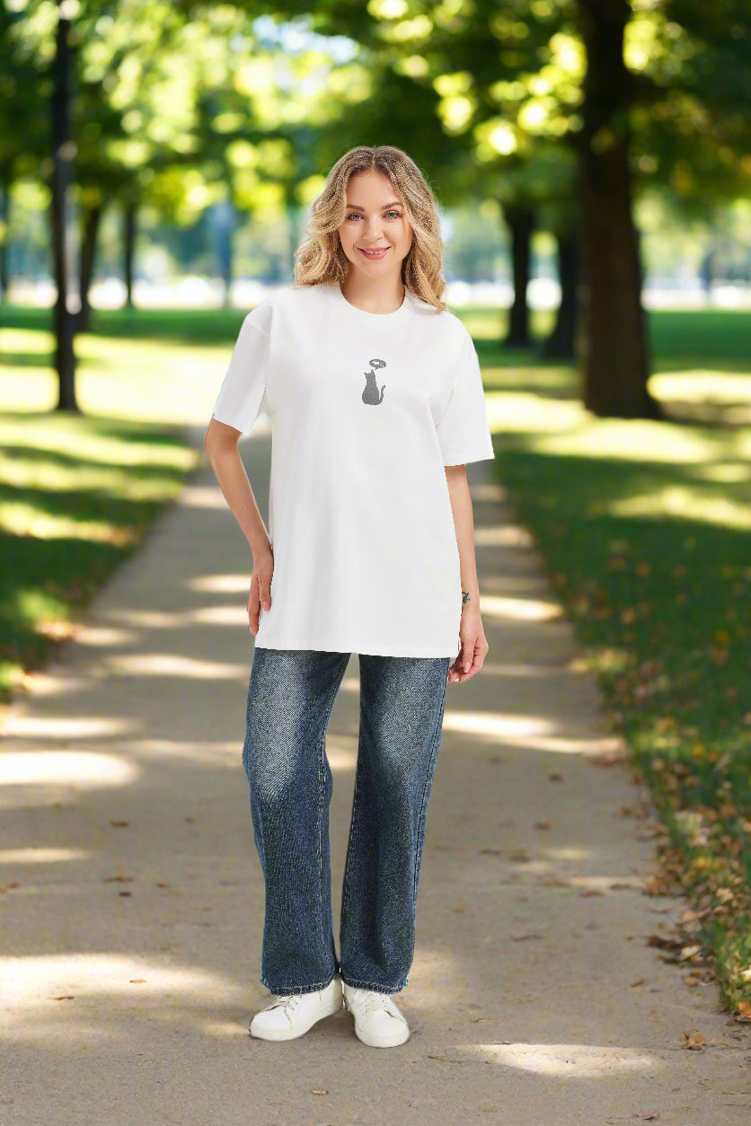 Woman in a white graphic t shirt with a small cat and thought bubble print
