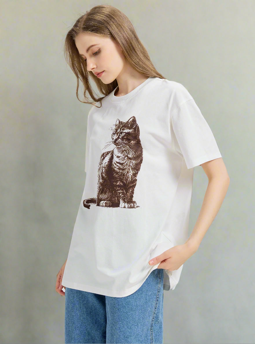 Woman wearing a white t-shirt with a cat graphic 