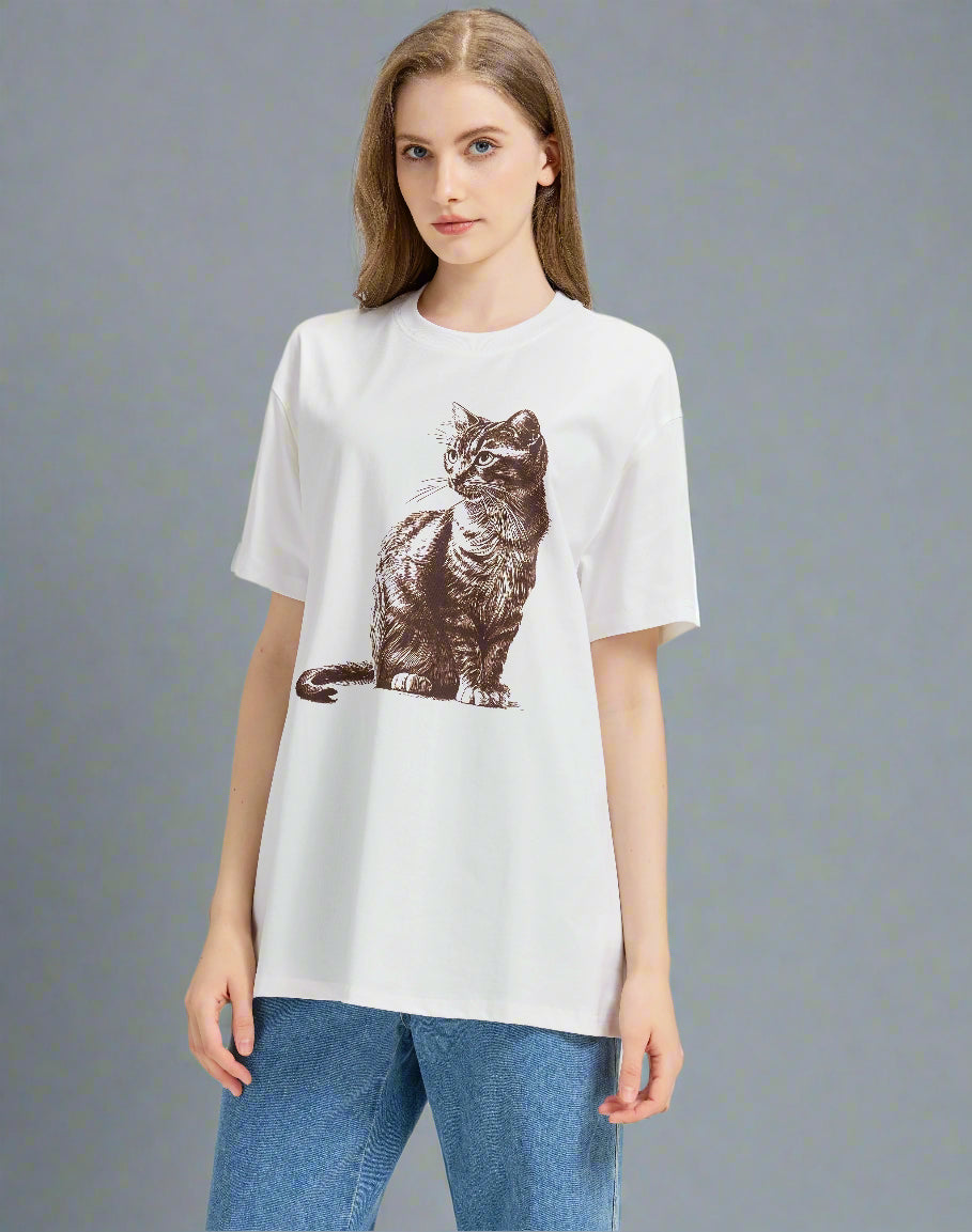 Woman wearing a white t-shirt with a brown cat print on a plain background