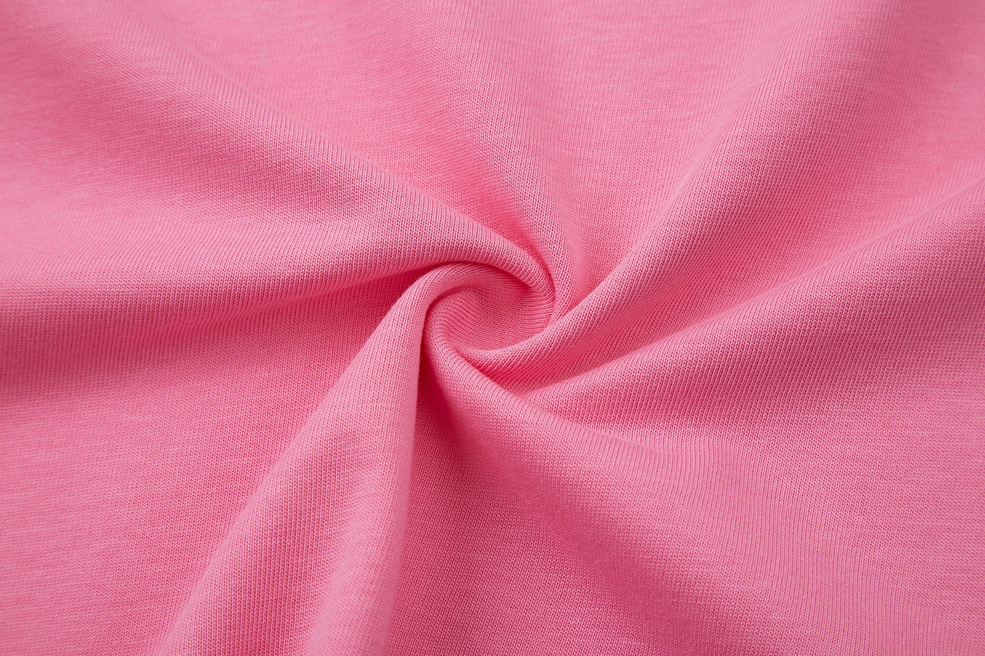 Close-up of pink fabric with a swirl pattern