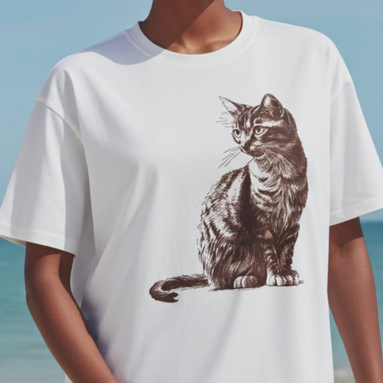 Woman in a white tee with a cat graphic print