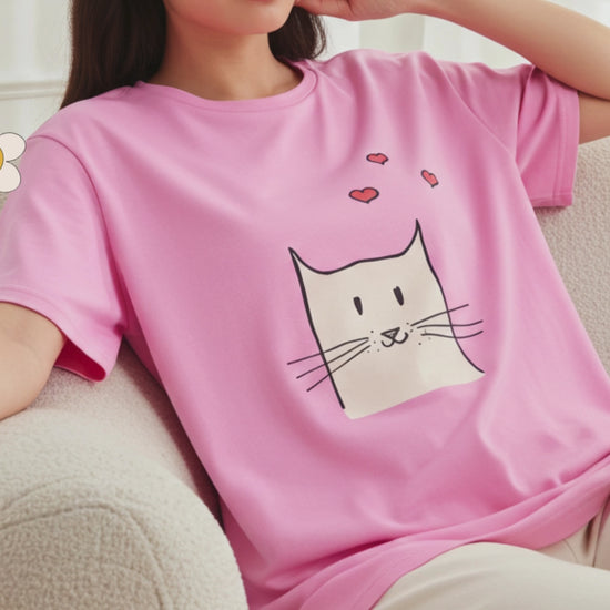 Woman wearing a pink tee with cat graphic